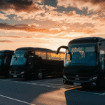 A row of black charter buses parked in a lot, showcasing their sleek design and spacious interiors.