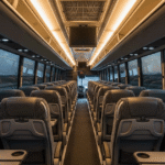 A charter bus interior showing empty seats with a view of the road ahead, illustrating seating capacity options.