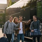 Friends boarding the bus with luggage.