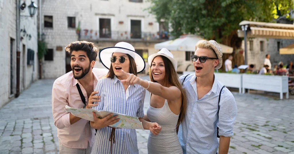 Luxury group travelers exploring the city together with a map.
