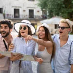 Luxury group travelers exploring the city together with a map.