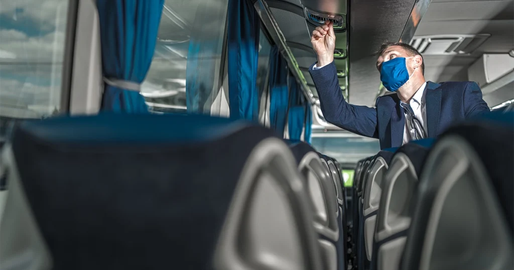 Charter bus interior amenities including overhead storage and seating